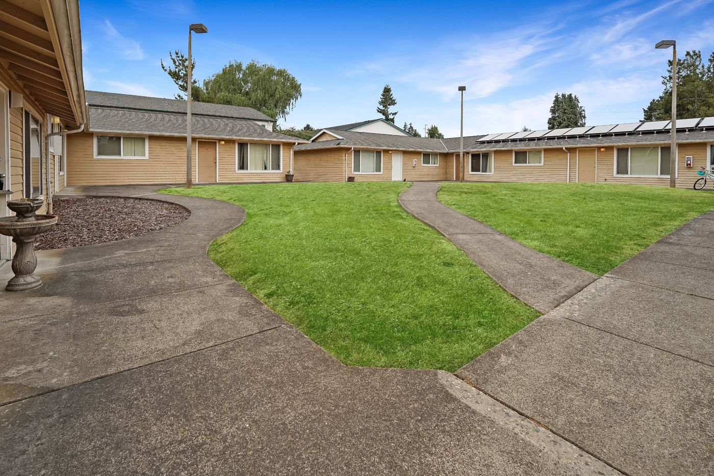 Courtyard lawn and walkways at Cora Park Apartments