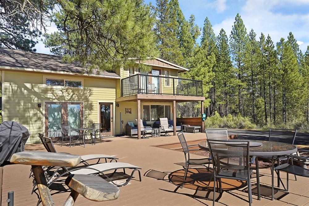 The Marten Cabin deck with lounge chairs under the pines